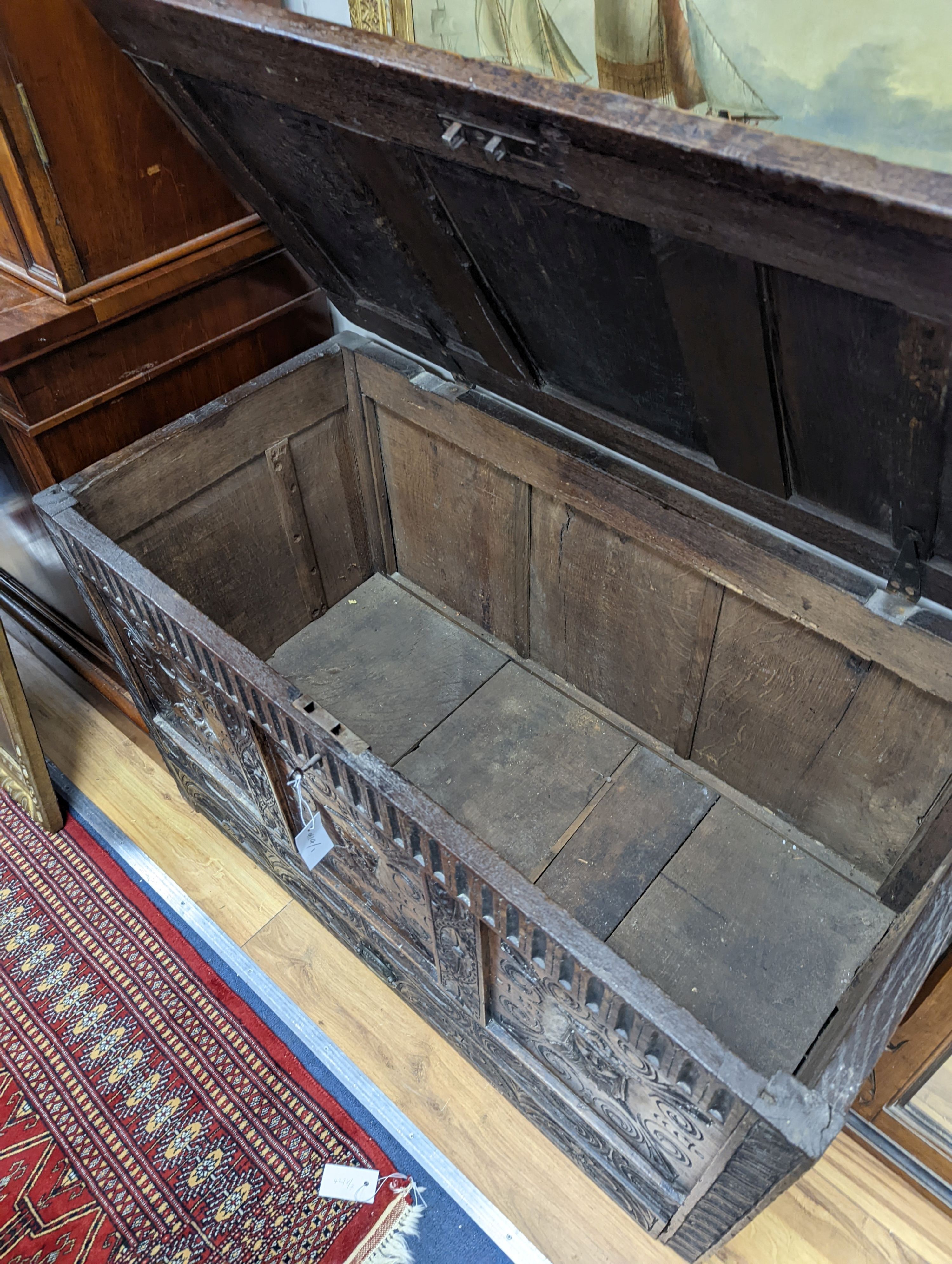 An 18th century oak mule chest with later carved decoration, length 103cm, depth 53cm, height 66cm